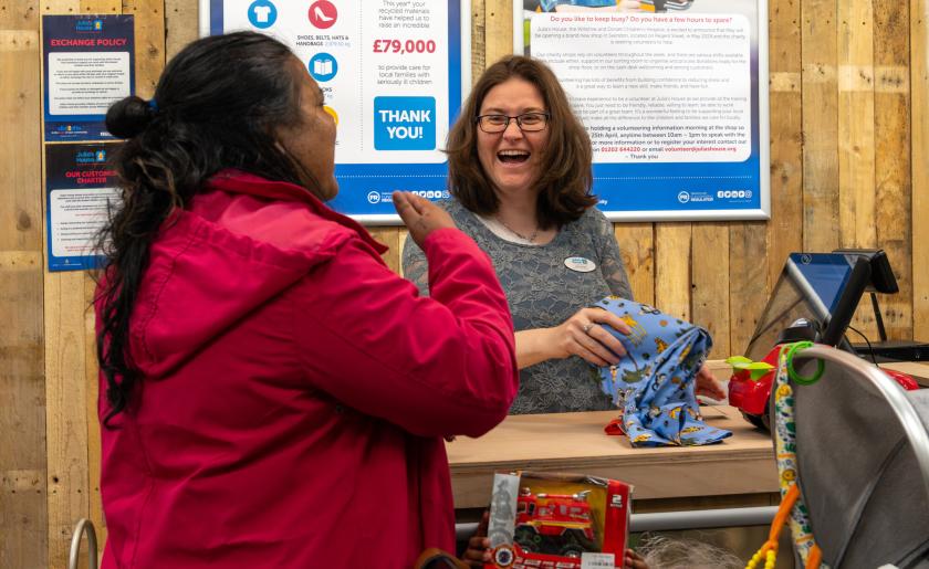 Assistant Manager Lee Hardy laughs with customer in Swindon shop