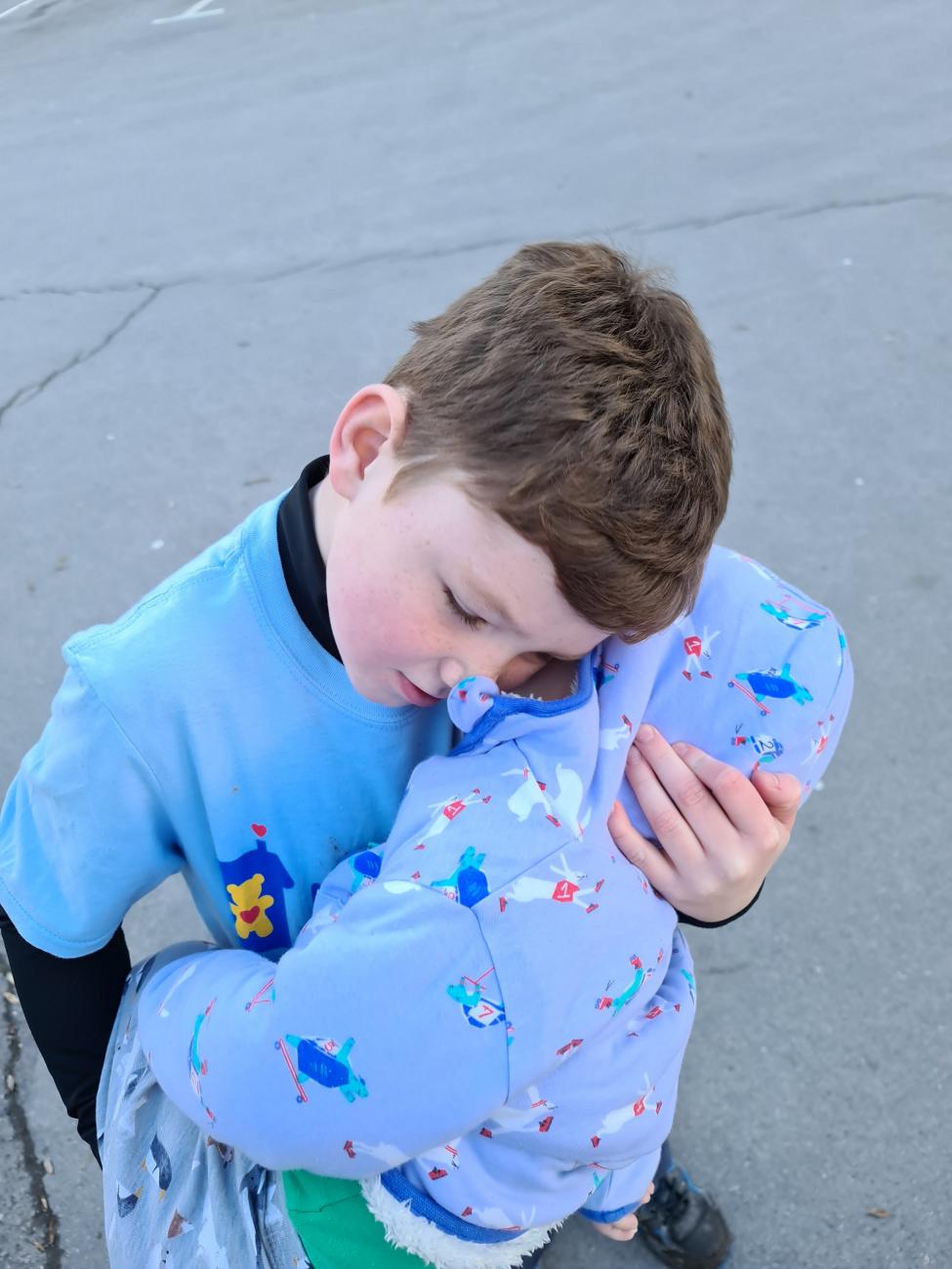 Harry has a cuddle boost from baby brother Reuben