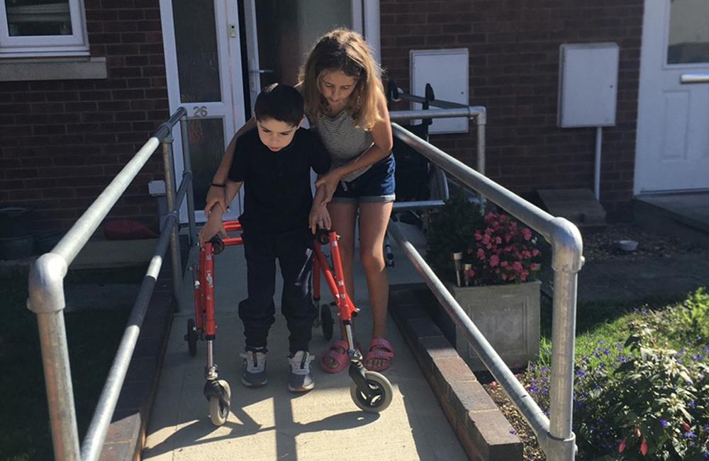 Evie helping Jack down the garden path