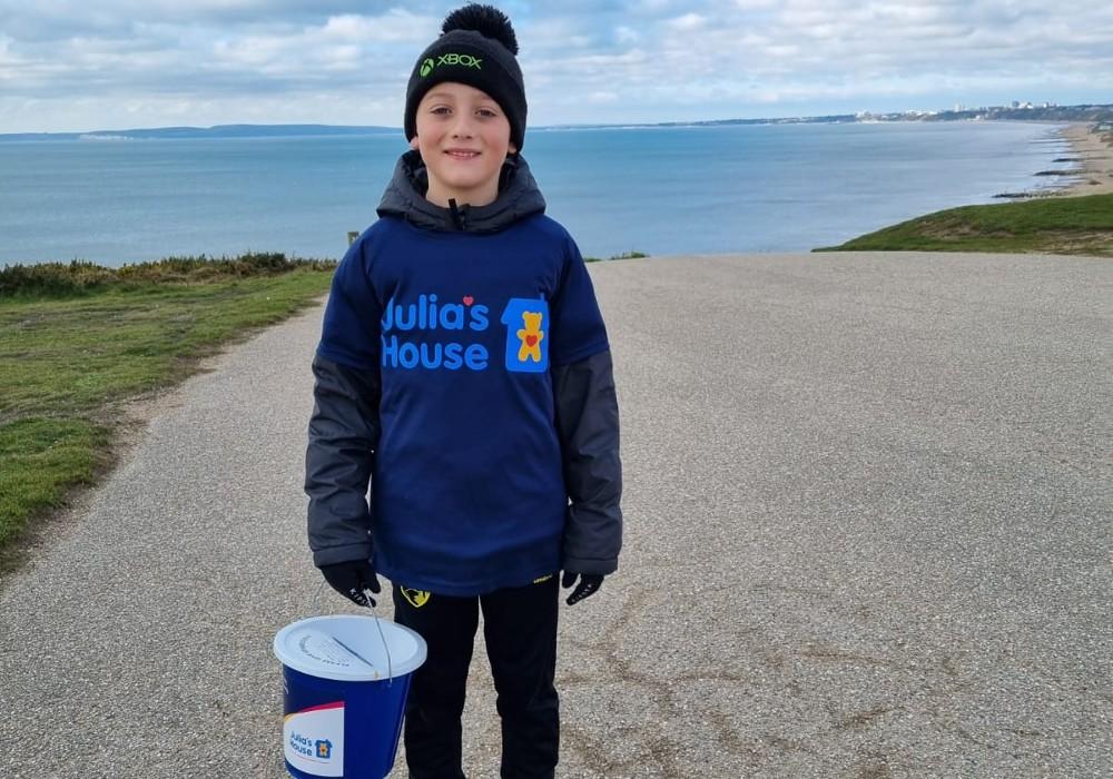 Zak, a Julia's House young Fundraiser with a collection bucket