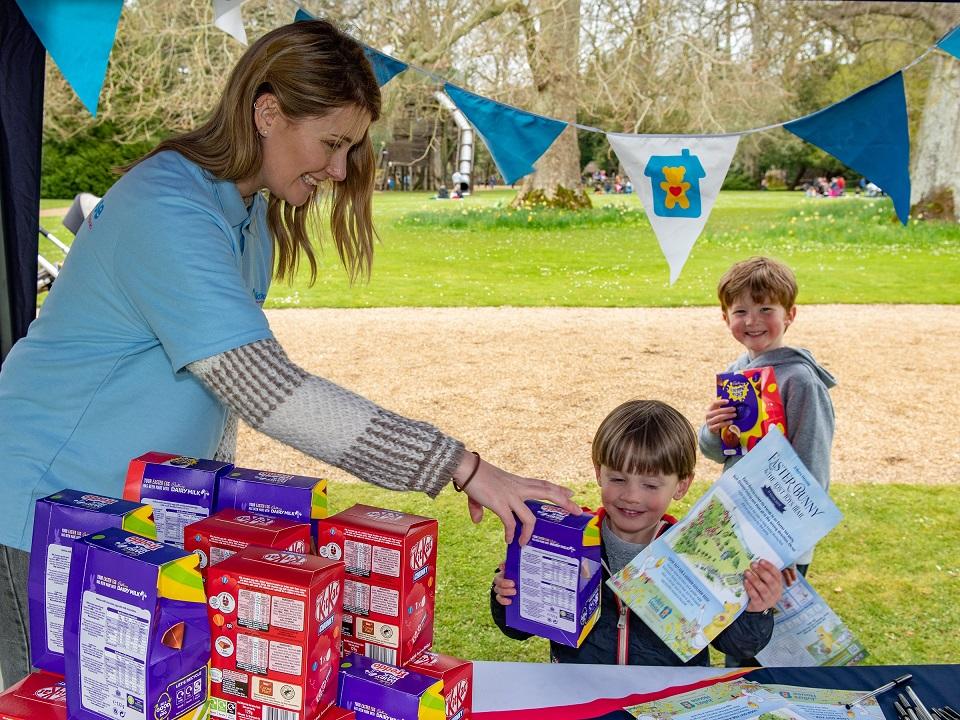 Volunteer from Parker Bullen Solicitors hands out Easter prizes