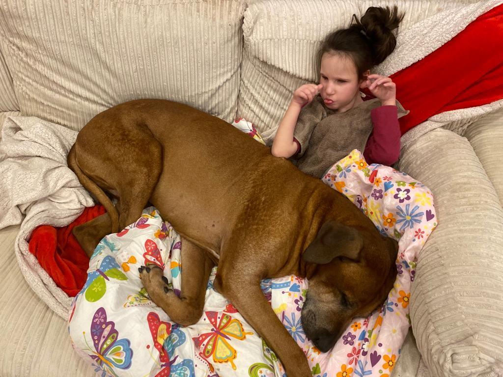 Sophia enjoys cuddles with her pet dog Odin