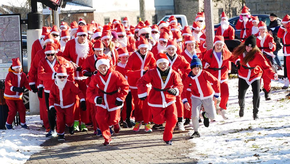 Group of people wearing Santa suits