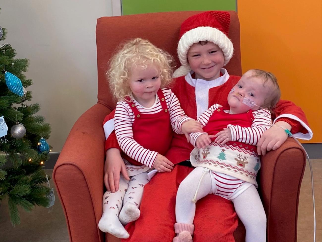 Harry cuddles with Isla and big sister Darcey