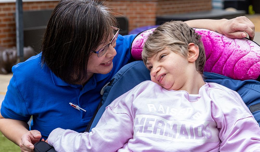 Julia's House nurse with a child in a wheelchair