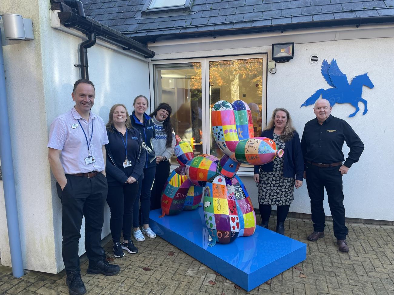 Julia's House team stand with Swindog Patches and supporters Jo and Del Hall outside hospice