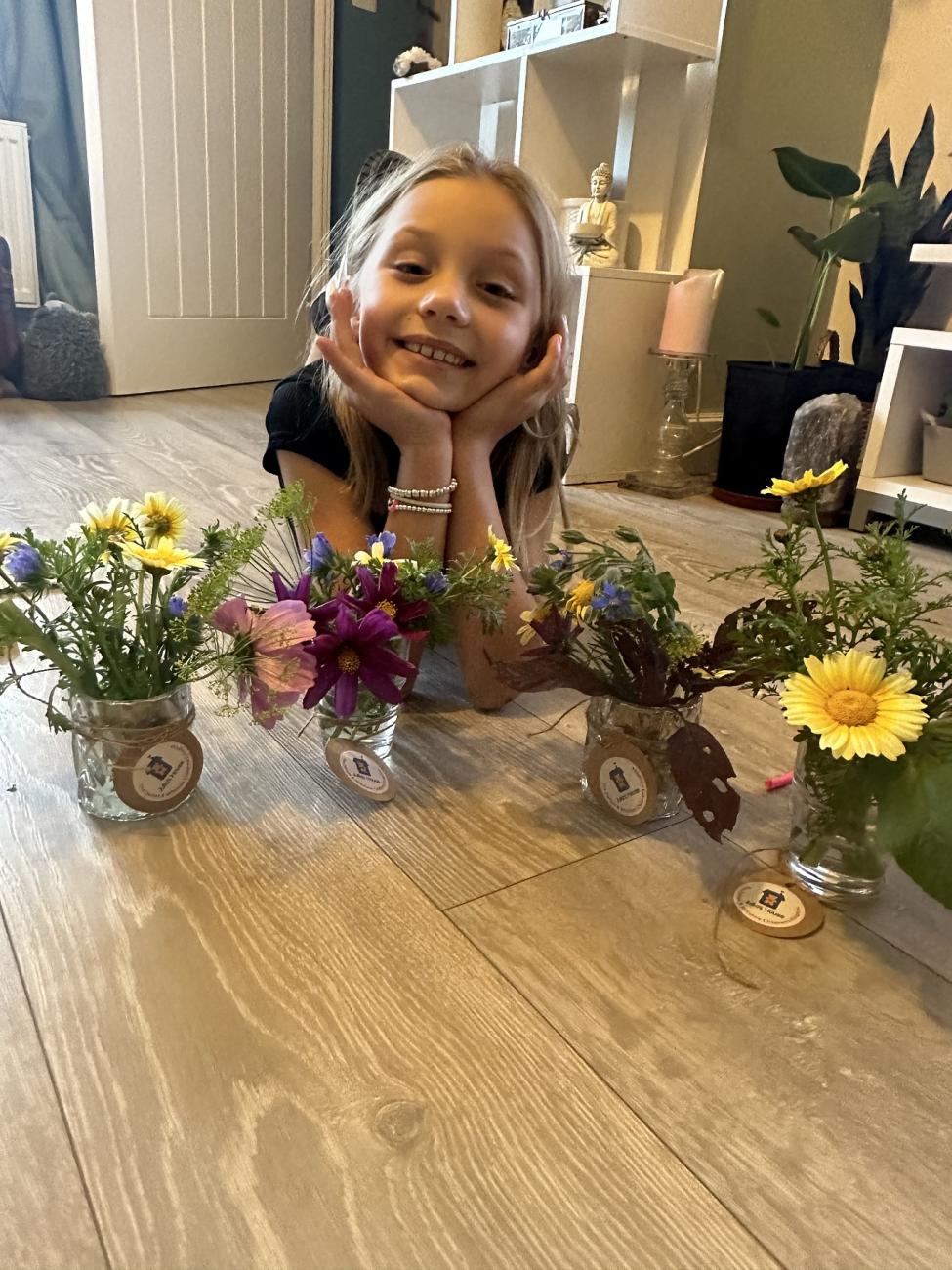 Young fundraiser Romi-Rae shows her wildflower bunches