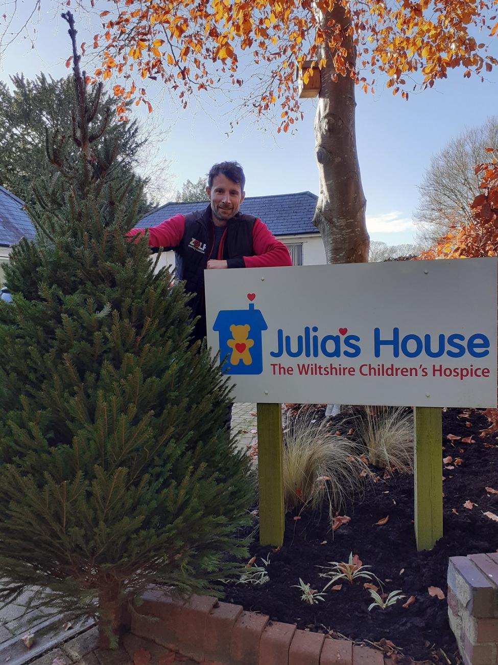 Zelf's Kevin Harris stands with tree by Julia's House hospice