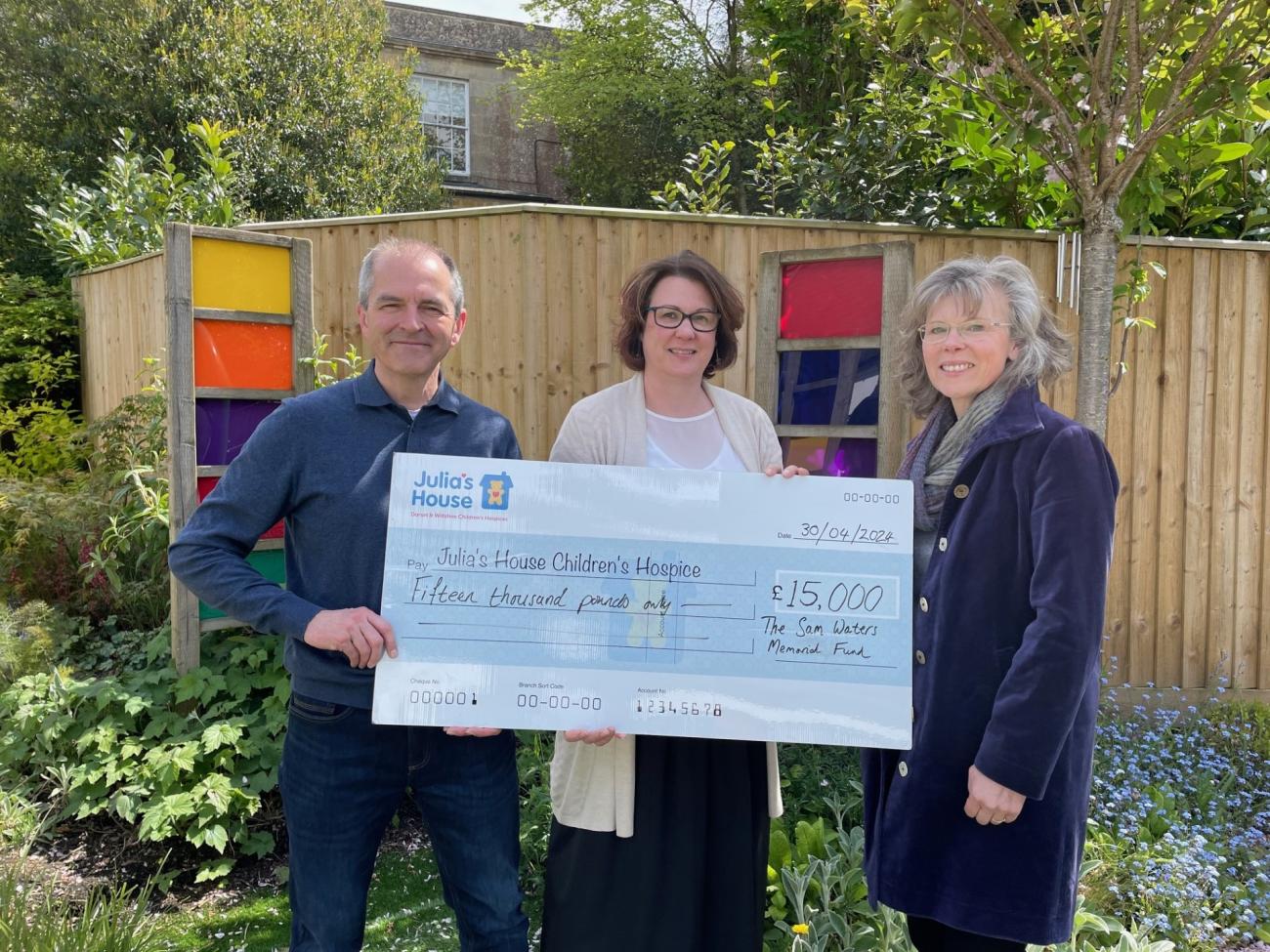 Howard and Susi Waters present cheque to Julia's House fundraiser Karen Harrison