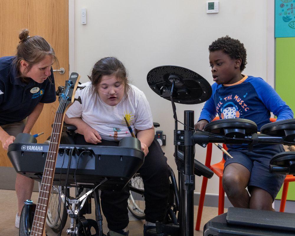 A boy on the drums and a girl playing the keyboard