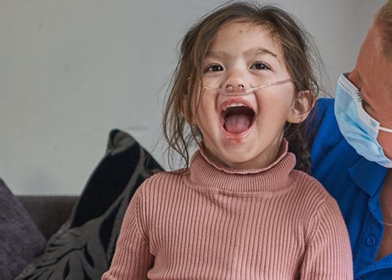 Isabella laughing with her nurse